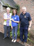 Girl Guide Phoebe Roberts receiving £100 from Honiton Lions